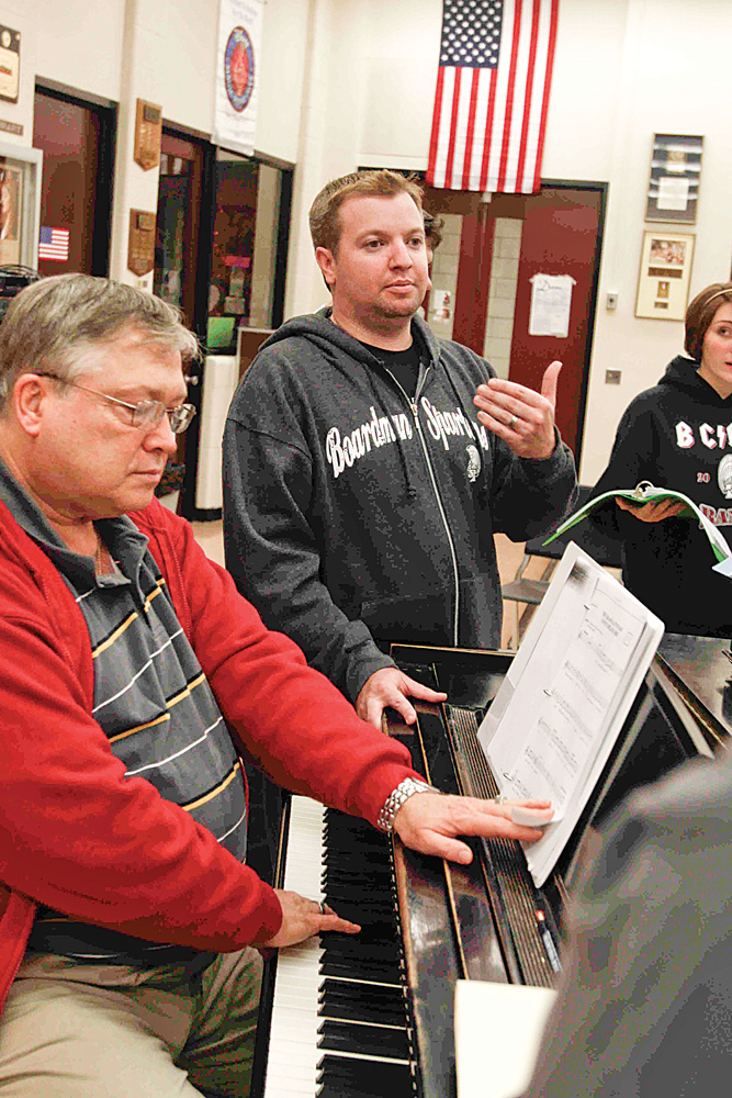 STAGE COACH: David Mullane, right with Errol Kehrberg, speaks to students at a rehearsal for the Boardman Drama Guild’s fall production, “25th Annual Putnam County Spelling Bee.” The guild tackles high-profile productions such as “Chicago” and “Footloose.” In photo at top, from left, Tyler Moliterno, Katelyn Deladurantey, Kehrberg and Mullane prepare for the the fall musical. The group rehearses several days each week in the months leading up to the Nov. 19-22 production.