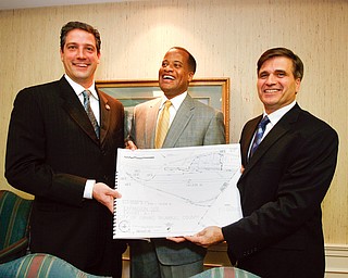 NEGOTIATIONS OVER: From left, U.S. Rep. Tim Ryan of Niles, D-17th, Youngstown Mayor Jay Williams and Girard Mayor James Melfi show a site plan for a 191-acre site along the Youngstown/Girard border that could be the location of a $970 million V&M Star Steel expansion. It took the two cities weeks to work out an agreement to annex the property, located in Girard, to Youngstown to clear the way for the project.