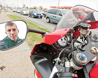 DANGER ZONE: Joey Dixon of Austintown stands alongside his brother’s Suzuki motorcycle at one of the most-dangerous intersections in Mahoning County — Mahoning Avenue and state Route 46 in Austintown. Dixon’s own motorcycle was totaled when he was in an accident at the intersection this past summer. He escaped without serious injury.