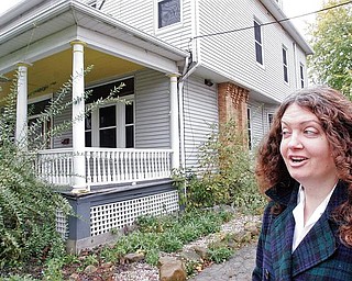 Audrey Presbylski , a community activist with an interest in historical preservation, stands near a house at 104 Wallace Ave, New Castle. She is one of a group New Castle area residents opposed to the house being demolished to make a parking lot. wd lewis