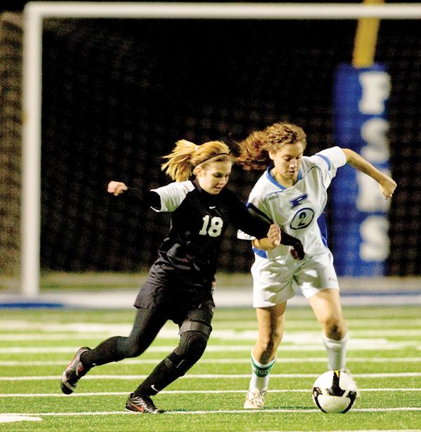 LAKE IS NEXT: Poland’s Vivien Clayton, right, struggles to maintain control of the ball while defended by Canton McKinley’s Tiara Smothers. Poland won and will play Uniontown Lake in the next round.

