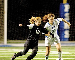LAKE IS NEXT: Poland’s Vivien Clayton, right, struggles to maintain control of the ball while defended by Canton McKinley’s Tiara Smothers. Poland won and will play Uniontown Lake in the next round.

