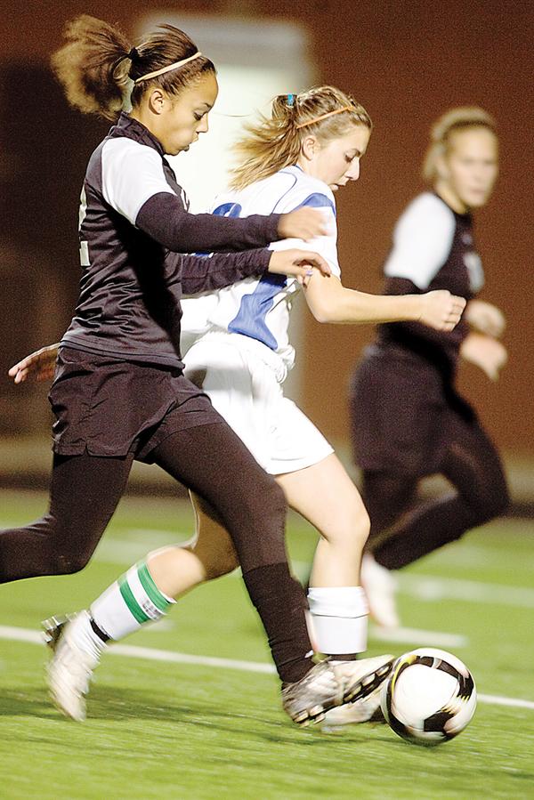 The Vindicator/Geoffrey HauschildPoland's Vivien Clayton struggles to mantain control of the ball while defended by Canton McKinley's Tiara Smothers during the first half at Poland High School on Monday evening.10.19.2009