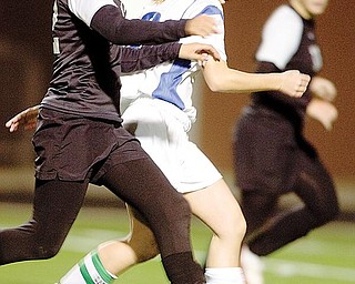 The Vindicator/Geoffrey HauschildPoland's Vivien Clayton struggles to mantain control of the ball while defended by Canton McKinley's Tiara Smothers during the first half at Poland High School on Monday evening.10.19.2009