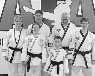 STATE CHAMPIONS: Six students of the Boardman ATA Black Belt Academy won state championships this year in Korean Taekwondo.  Pictured (left to right), first row: Brandon Breznai. Second row: Kim Campos, Caitlin Currier, Brielle Campos. Third row: Shawn Menousak, Robert Long (academy owner). Missing from photo is Yianni Koulianos. All except Long won state titles this year.

