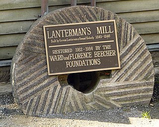 GRINDSTONE:  This grindstone is an example of the actual stones used in the milling of flour by Lanterman’s Mill. The divots in the stone act as knives to remove the hard hulls of buckwheat and corn, and the flat surfaces grind the grains into flour, a mill official said.