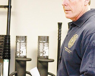 NEW GEAR: Lt. Robin Lees, commander of the Mahoning Valley Violent Crimes Task Force, discusses new breaching tools purchased with $12,000 of federal forfeiture funds. The collection of equipment displayed in the roll-call room of the sheriff’s department includes battering rams and sledgehammers of varied sizes. 