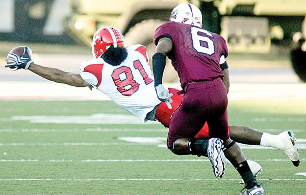 LOOKING AHEAD: Youngstown State’s Donald Jones (81) reaches for a pass while being watched by Southern Illinois’ Brandon Williams (6) during the Salukis’ 27-8 win over the Penguins on Saturday in Carbondale. The Penguins are preparing to take on South Dakota State this Saturday.
