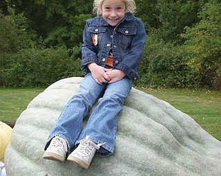 Kaitlin Burich of Austintown sits atop a giant gourd!          