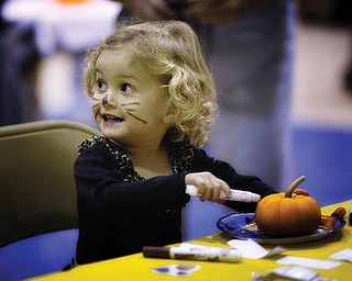PURR-FECT PUNKIN: 2-year-old Hannah LaPlante was captured in this picture by her father, John, while she was painting a pumpkin at the Poland Halloween Parade last weekend.
