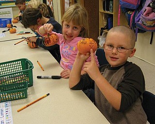 Thereasa Clark and Dean Coman were among the kindergarten students at Ellsworth Elementary School who decorated pumpkins, courtesy of the Green Team.
