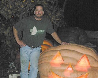 GOOD GOURD! Harvey Crowley poses with the 845-pound pumpkin he grew this year.
          