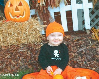 JACK O'LANTERN: Jack Buchner, 9 months, seems pleased with his first jack o'lantern.