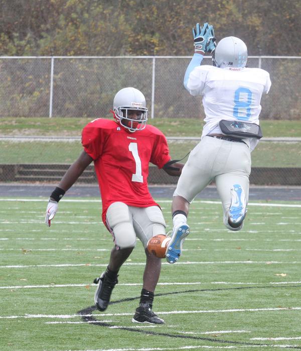 FOOTBALL - (8) Lilton Morris of East blocks the punt of Anthony Cornwell during their game Saturday afternoon. - Special to The Vindicator/Nick Mays