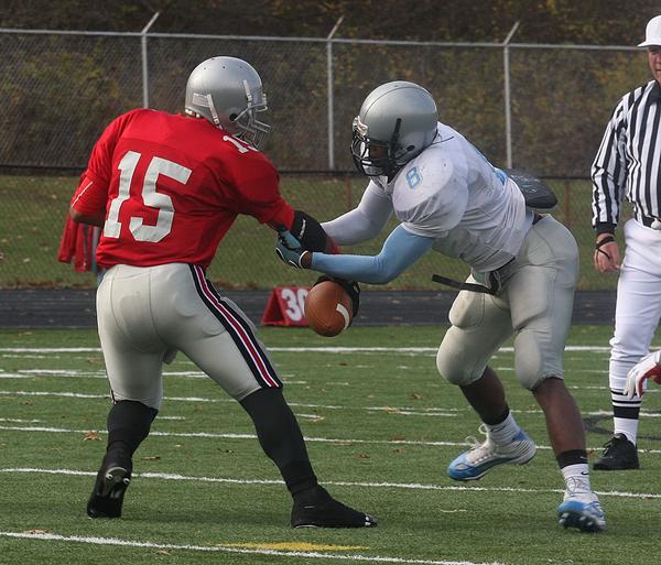 FOOTBALL - (8) Lilton Morris of East tries to strip the ball from (15) Carlos  Colon during their game Saturday afternoon. - Special to The Vindicator/Nick Mays