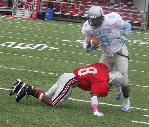 FOOTBALL - (8) Lilton Morris of East is hit by (8) Lerone Burley during their game Saturday afternoon. - Special to The Vindicator/Nick Mays