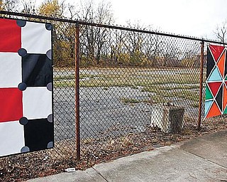 THEFT: An empty space marks the location of a stolen piece of art on a fence on Wick Avenue on Youngstown’s North Side. Thirty seven artworks were hung on the fence Oct. 24. Three were stolen early Saturday morning. The urban beautification project is the work of Art Youngstown.