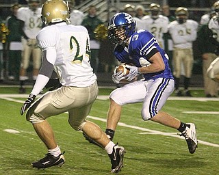 POLAND - (34) Luke Wollet is off on a long gain as he puts a move on (24) Mike Kagafas during their game Friday night in Poland. - Special to The Vindicator/Nick Mays