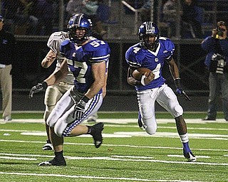 POLAND - (4) Darius Patton follows the blocking of (57) David McLaughlin for a big gain Friday night in Poland. - Special to The Vindicator/Nick Mays