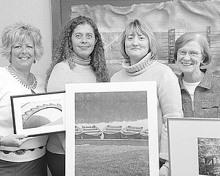 Special to The Vindicator
PICTURE THAT! A few of the donated pieces of art to be auctioned as a benefit for the Ursuline Sisters HIV/AIDS Ministry on Saturday are displayed by, from left, Cheryl Streb-Baran, clinic director; Jessica Sheppard, child and family program director; Brigid Kennedy, associate director; and Sister Kathleen Minchin, executive Director.