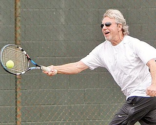 TENNIS ANYONE? Mike Phelps of Boardman enjoys a game of tennis at Boardman Park, enjoying the unseasonably warm weather Monday.
