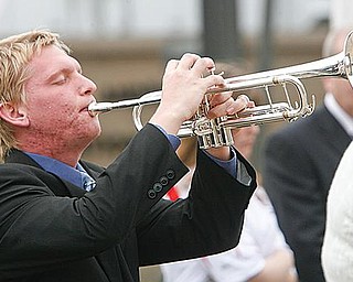 SOLEMN CEREMONY: Tim Daniels, a music major at YSU, plays taps at the conclusion of the ceremony on Veterans Plaza. The names of 64 former YSU students and alumni who died in the line of duty while serving in the military were read during the program. Most died in World War II.