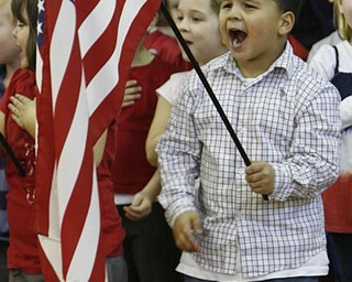 The Vindicator/Robert K. Yosay -----Carlos Irizarry sings 'God Bless America" as he and his fellow students put on a show for the veterans in attendance at the West Elementary School in Boardman
111120009