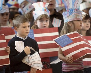 The Vindicator/Geoffrey Hauschild
Anthony Gaglardi, age 6 and a first grader in Mrs. Hudak's class, listens to a playing of the National Anthem during a Veterans Day Event at Roosevelt Elementary in Hubbard Wednesday afternoon.
