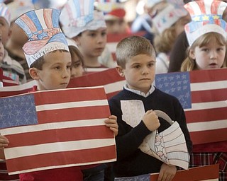 The Vindicator/Geoffrey Hauschild
First graders from Mrs. Hudak's class, Logan DiPiero, and Anthony Gaglardi, both age 6, listen to a playing of the National Anthem during a Veterans Day Event at Roosevelt Elementary in Hubbard Wednesday afternoon.