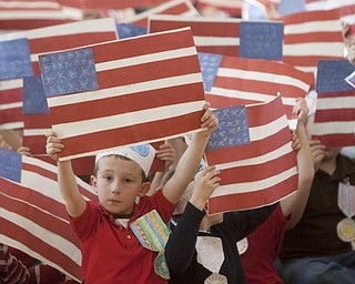 The Vindicator/Geoffrey Hauschild
Logan DiPiero, age 6 and a first grader in Mrs. Hudak's class, waves an American Flag while patriotic music was played during a Veterans Day Event at Roosevelt Elementary in Hubbard Wednesday afternoon.