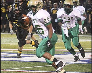 FOOTBALL - (26) Akise Teague of Ursuline breaks off a punt return for a touchdown Friday night in Austintown. - Special to The Vindicator/Nick Mays