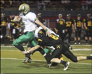FOOTBALL - (4) Paul Kempe of Ursuline breaks the tackle of (8) Jacob Danks and scores on a long run during their game Friday night in Austintown. - Special to The Vindicator/Nick Mays