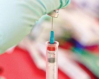 VACCINES ADMINISTERED: Volunteers administered the H1N1 vaccine to Canfield High School students and community members Friday during a clinic in the high school gymnasium. The vaccine comes in both an injection and nasal spray form.