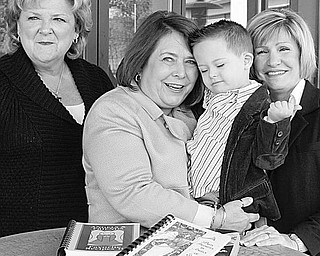 The Vindicator/William D. Lewis
ANGELIC: Preparing for the Angels for Easter Seals Annual Holiday Brunch and Sweet Shoppe are, left to right, co-chairs Nancy Leicht and Mary Celeste VanSickle, holding Christian Trella, 3; and President Phyllis Bacon. The Angels will be selling more than 30 varieties of homemade cookies, among other types of baked goods.