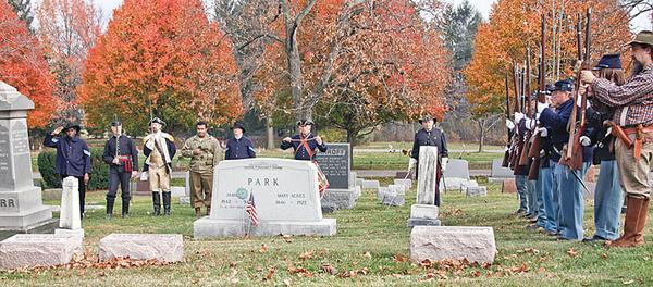 SALUTE: War re-enactors honor the fallen of three wars at a ceremony Sunday at Canfield Cemetery.