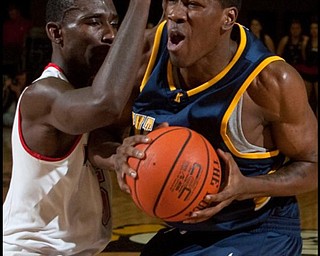 The Vindicator/Geoffrey Hauschild
YSU's Sirlester Martin (5)defends Kent State's Anthondy Simpson (21) during the first half at Beeghly Center on Wednesday afternoon.