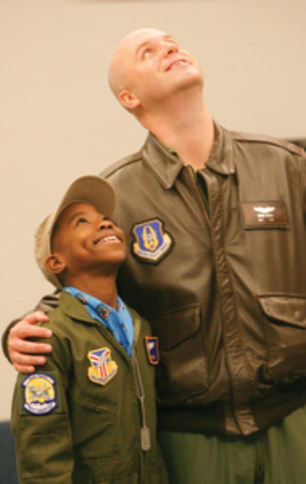 HONORARY MEMBER: Alan Hinton, 11, of Youngstown, stands with his mentor Capt. Brian Hodor, who is a pilot of the C-130 aircraft in the Air Force Reserve. Alan was sworn-in Wednesday as an honorary Air Force Reserve second lieutenant in the “Pilot for a Day” program at the Youngstown Air Reserve Station.