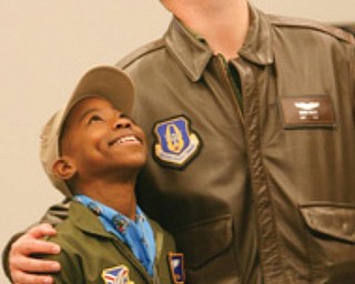 HONORARY MEMBER: Alan Hinton, 11, of Youngstown, stands with his mentor Capt. Brian Hodor, who is a pilot of the C-130 aircraft in the Air Force Reserve. Alan was sworn-in Wednesday as an honorary Air Force Reserve second lieutenant in the “Pilot for a Day” program at the Youngstown Air Reserve Station.