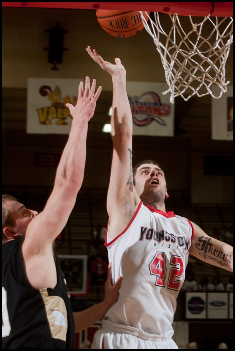 The Vindicator/Geoffrey Hauschild
YSU's Dallas Blocker unsuccessfully goes up for a layup while defended by Geneva's Matt Blocki during the first half of the game at Beeghley Center on Tuesday evening.
11.24.2009