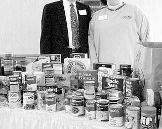 Special to The Vindicator
GATHERED TOGETHER: Members of Canfield Republican Women’s Club conducted a drive for nonperishable food items at their Nov. 4 meeting. Above, Sarah Graziani, chair of the club’s Caring For America Committee, represented the club when she presented the donated items to Andrew Skrobola for the Knights of Columbus Food Pantry. CRWC will continue its Caring for America program by contributing to the Toys for Tots Campaign at its Dec. 2 meeting. 