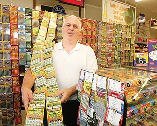 LOTTO SALES: John Colla of Collas Market in Austintown has long had one of the busiest lottery sales in Mahoning County. Colla said the downturn economy has spurred lottery sales even higher.