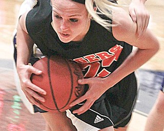 HARD-FOUGHT MATCH: Lowellville’s Ashley Moore (5) and Springfield’s Ashley Davis (24) fight for possession of the ball during the second period of Monday’s game at Lowellville High School gym. The Tigers defeated the Rockets, 59-51.