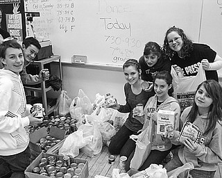 COLLECTIBLES: Students of St. Patrick School in Hubbard proudly display a portion of the items they have collected during food drives to replenish a food bank operated by St. Vincent de Paul at St. Patrick Church. In addition to food drives, students enjoyed several Friday dress-down days and paid $1 or more to not wear a school uniform. Eighth-grade students collected more than 100 bags of clothing during a "Poorest of the Poor" clothing drive for the needy. The school has donated more than $150 to St. Vincent de Paul and raised more than $200 for the American Cancer Society.