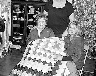 Special to the Vindicator
JUST THE TICKET: Members of Hubbard Historical Society sold raffle tickets for an Amish quilt to raise funds for the maintenance of the historic McBride House, 27 Hager St. Admiring the quilt is Donna Jean Cargill Ragozzine, seated at right, who held the winning ticket and received the quilt. Sharing the happy moment are, seated at left, her mother, Mary Jane Harbison, and standing, her sister-in-law, Sherry A. Cargill.
