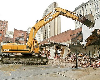 DEMOLITION: Pro Quality Land Development of Campbell is demolishing three vacant buildings near Youngstown City Hall. The land will be converted into a parking lot addition.