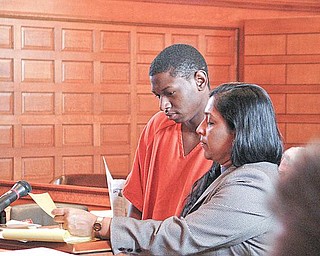 IN COURT: Oryan Miller of Warren reads along with his attorney, Sarah Kovoor, in Trumbull County Common Pleas Court.