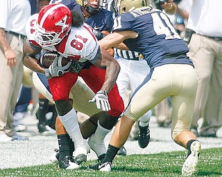 YSU'S Donald Jones is corralled by Pitts #41 Andrew Taglianetti and  AAron Berry during first half action at Heinz Field in Pittsburgh. Sept. 5, 2009.