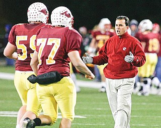 Cardinal Mooney head football coach PJ Fecko talks to players returning to the sideline.
