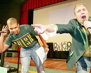 William D. Lewis/The Vindicator Steven Bernard, left, and Louis Isabella both Ursuline HS senoirs served as MC's during Ursuline HS pep rally Thursday afternoon in preparation for State Championship game. Rally was held in the school auditorium.