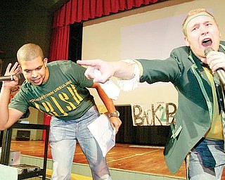 URSULINE RALLY: Steven Bernard, left, and Louis Isabella, Ursuline High School senior, serve as masters of ceremonies at the school’s pep rally in preparation for the Fighting Irish’s state championship game against Coldwater today in Canton. The rally was Thursday.